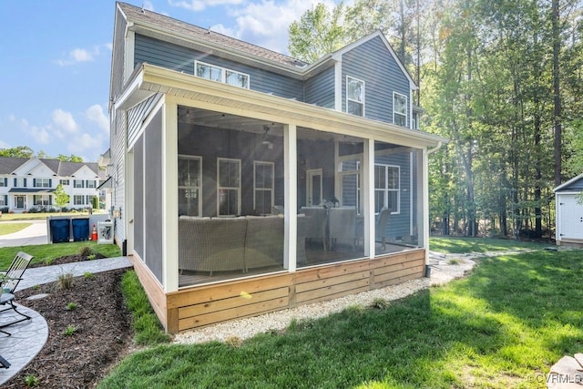 view of side of property with a yard and a sunroom
