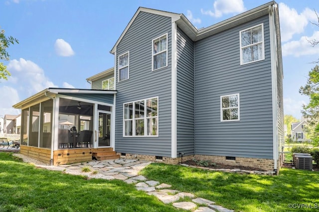 rear view of property featuring a sunroom, a lawn, central air condition unit, and crawl space