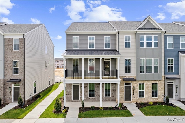12141 Morning Walk, Henrico, VA 23233 - townhome / multi-family property with a porch, a balcony, brick siding, a standing seam roof, and metal roof