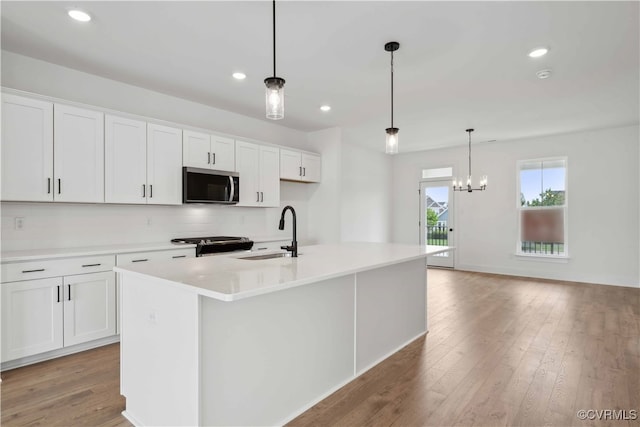 12141 Morning Walk, Henrico, VA 23233 - kitchen featuring stainless steel appliances, a sink, white cabinetry, a kitchen island with sink, and light wood finished floors