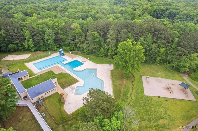 bird's eye view of a heavily wooded area and a pool area