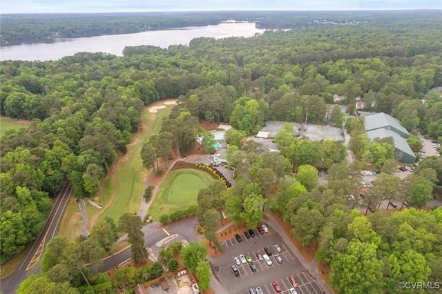 aerial view of property's location featuring a nearby body of water, a forest, and a local golf course