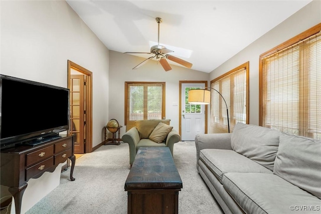 living area featuring ceiling fan, lofted ceiling, light colored carpet, and baseboards
