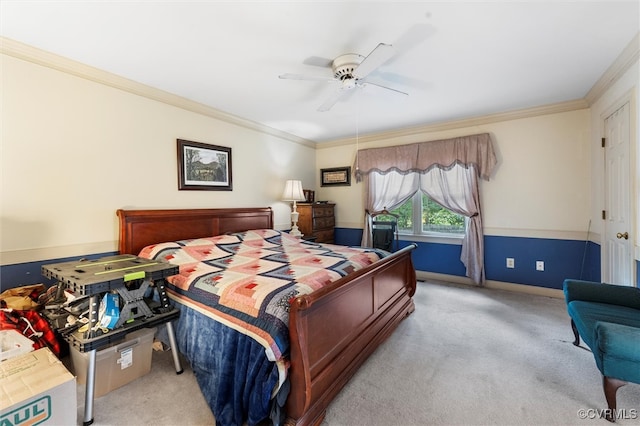 carpeted bedroom with crown molding, baseboards, and a ceiling fan