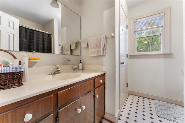 full bathroom with baseboards and vanity