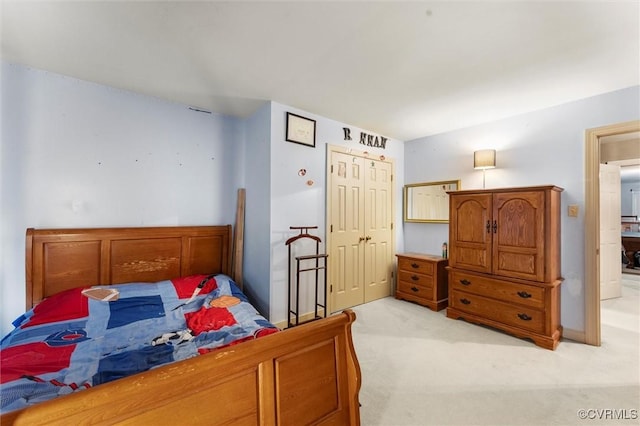 bedroom featuring light carpet and a closet