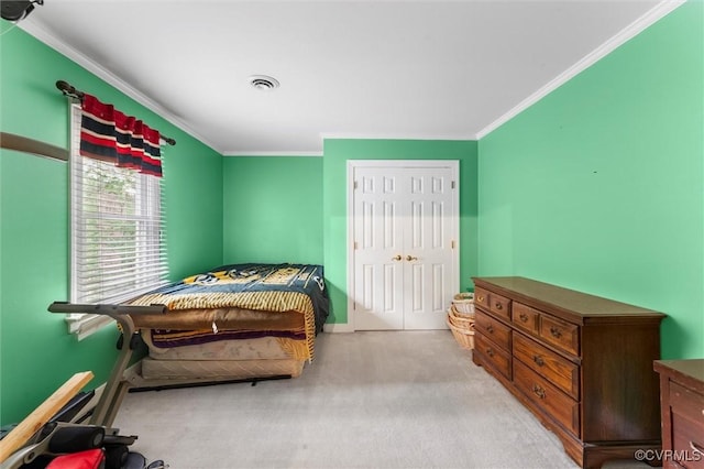 carpeted bedroom featuring crown molding, a closet, and baseboards