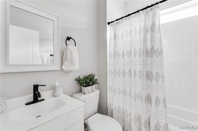 bathroom with toilet, shower / tub combo with curtain, and vanity