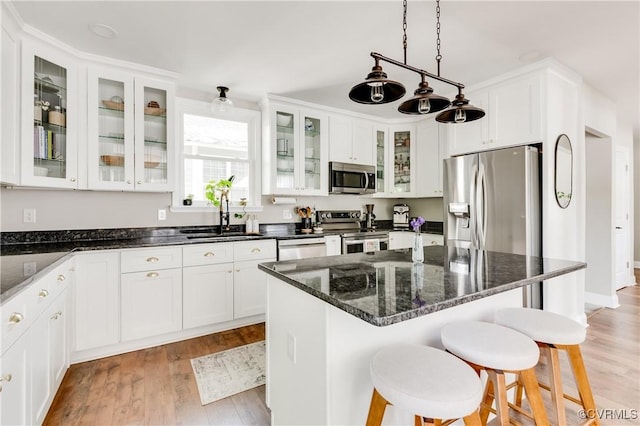 kitchen featuring a sink, white cabinets, and stainless steel appliances
