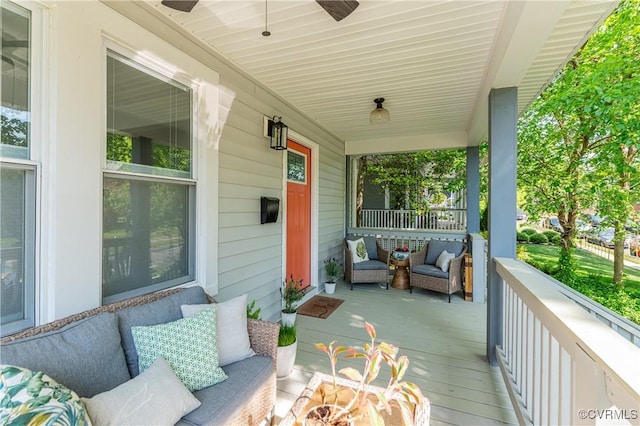 deck featuring a porch, ceiling fan, and an outdoor hangout area