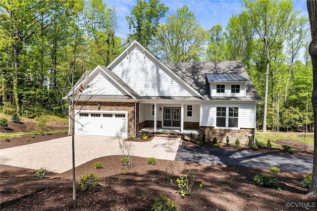 4236 Shirley Rd, Richmond, VA 23225 - craftsman house featuring driveway, an attached garage, a porch, and stone siding