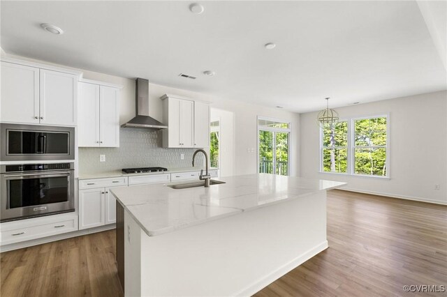 4236 Shirley Rd, Richmond, VA 23225 - kitchen with wall chimney range hood, a sink, gas cooktop, and wood finished floors