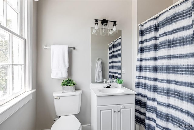 bathroom featuring toilet and vanity