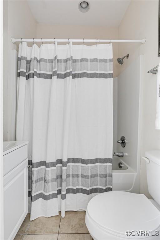 bathroom with vanity, tile patterned flooring, shower / bathtub combination with curtain, and toilet