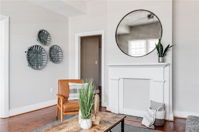 living area featuring baseboards and wood finished floors