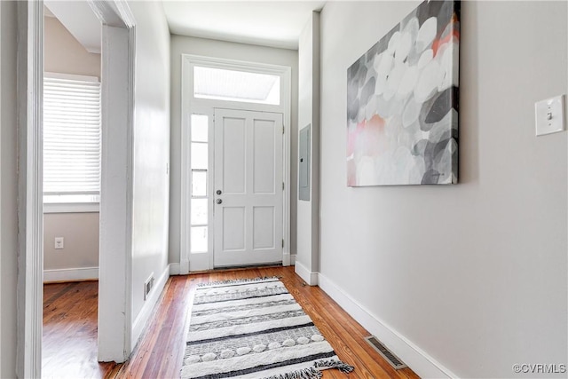entrance foyer with visible vents, light wood finished floors, and baseboards