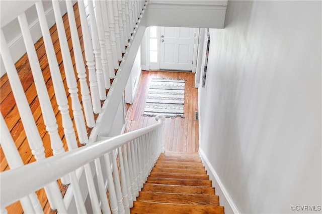 stairway featuring baseboards and wood finished floors