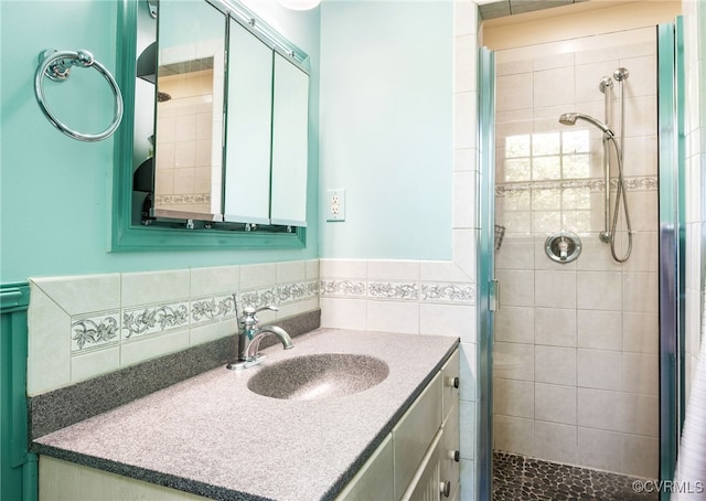 bathroom with a shower stall and vanity