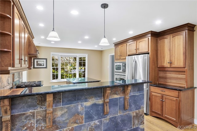 kitchen with open shelves, recessed lighting, dark stone countertops, appliances with stainless steel finishes, and decorative light fixtures