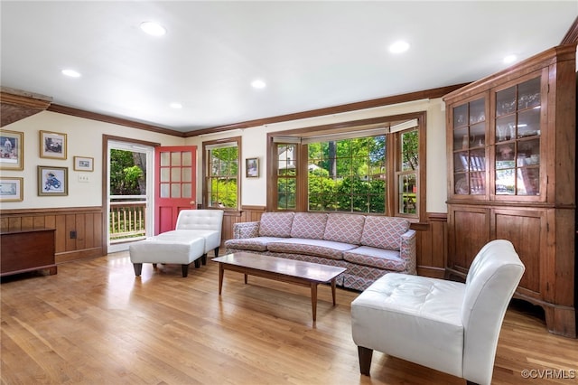 living room with crown molding, light wood finished floors, wainscoting, and recessed lighting