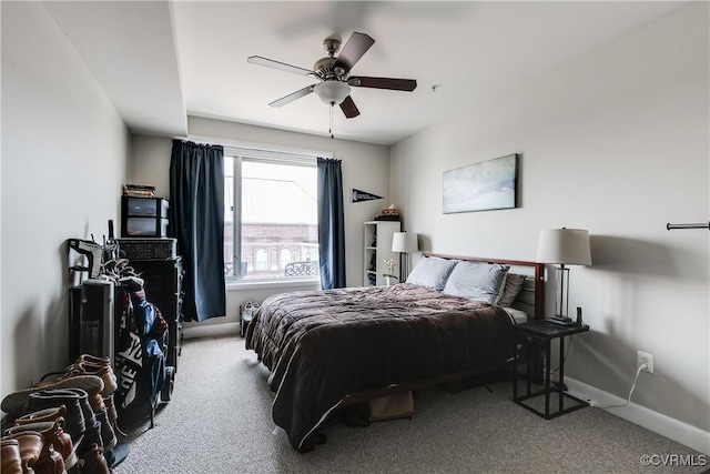 carpeted bedroom with baseboards and a ceiling fan