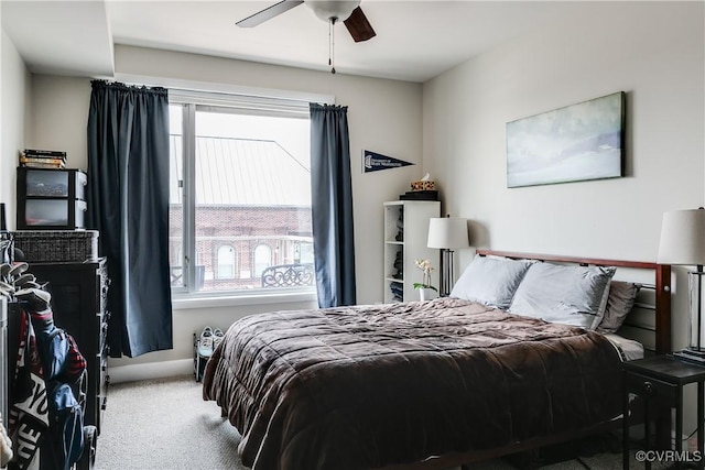 bedroom with multiple windows, a ceiling fan, and carpet floors