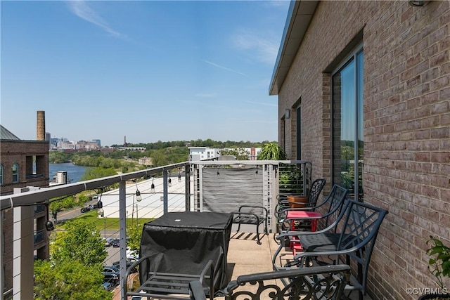 balcony with a grill and a water view