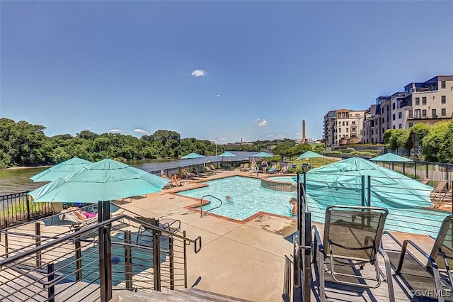 community pool featuring a patio and fence