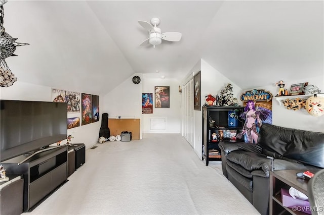 living area featuring carpet floors, a ceiling fan, and lofted ceiling