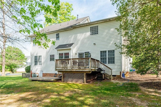 rear view of house featuring a yard, a deck, and crawl space