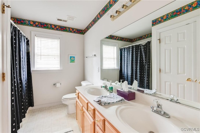 bathroom with a sink, baseboards, toilet, and visible vents