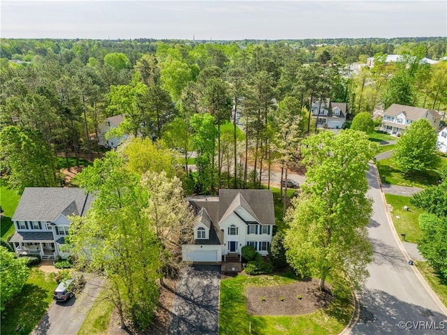 birds eye view of property with a forest view