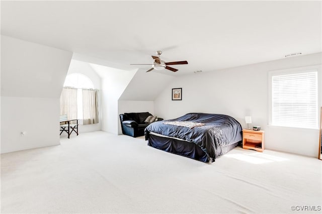 carpeted bedroom with visible vents, a ceiling fan, and lofted ceiling