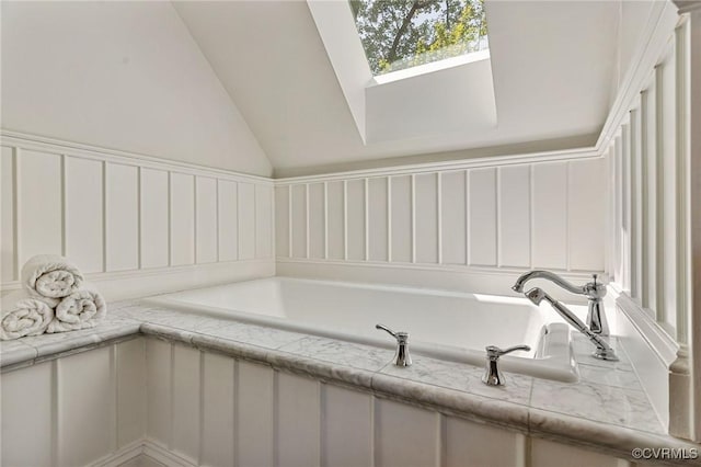interior space featuring a skylight and a bath
