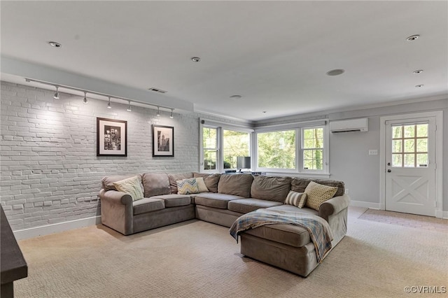 living area featuring track lighting, visible vents, baseboards, an AC wall unit, and light colored carpet