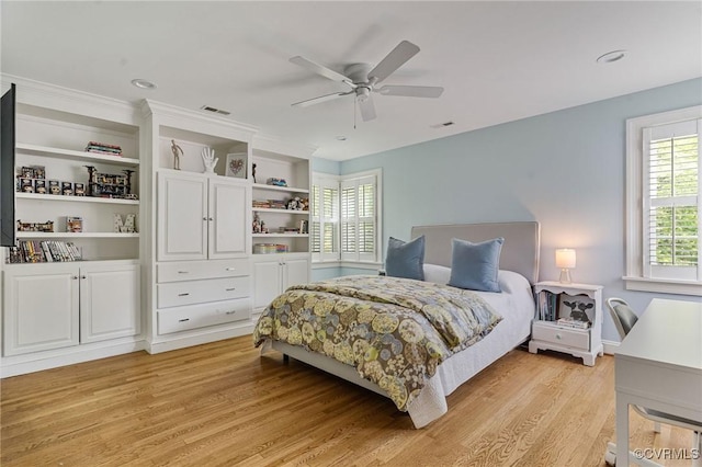bedroom featuring visible vents, a ceiling fan, and light wood-style flooring