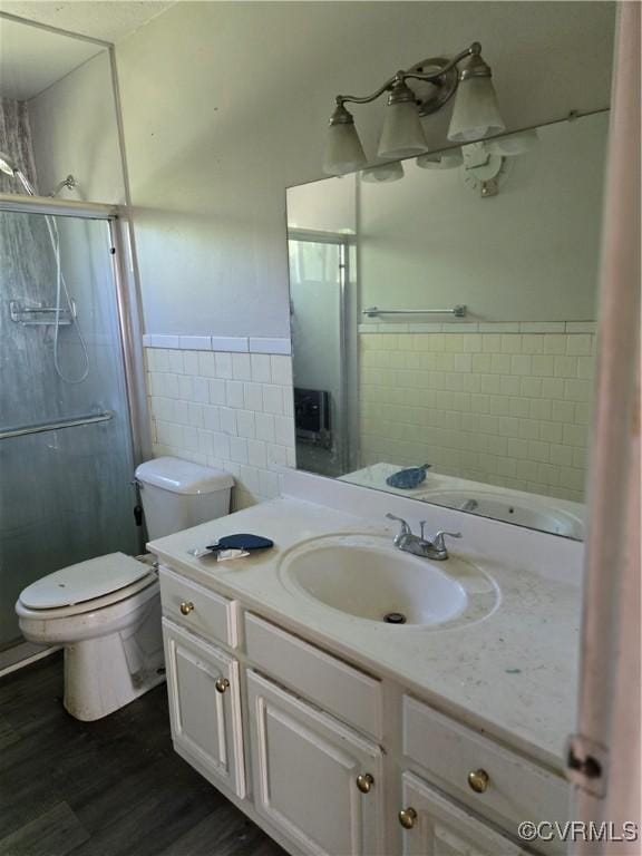 2306 Brockway Ln, Fairfield, VA 23223 - bathroom with tile walls, a stall shower, toilet, wood finished floors, and vanity