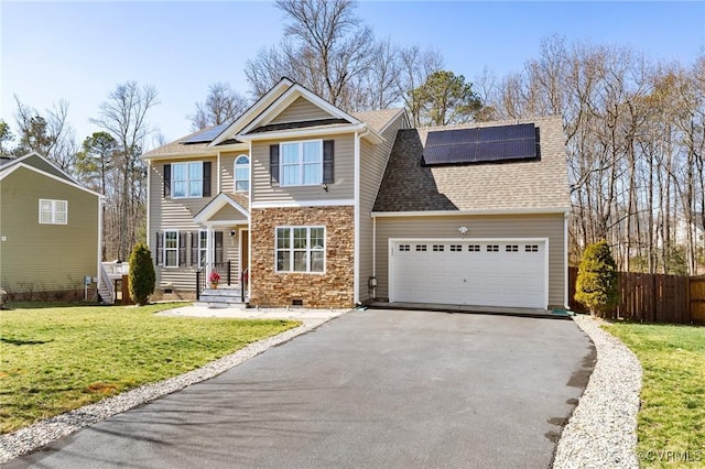 view of front of property with roof mounted solar panels, crawl space, aphalt driveway, and a front lawn