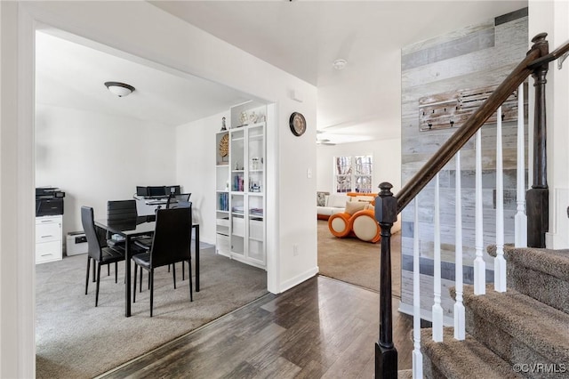dining area featuring wood finished floors and stairway