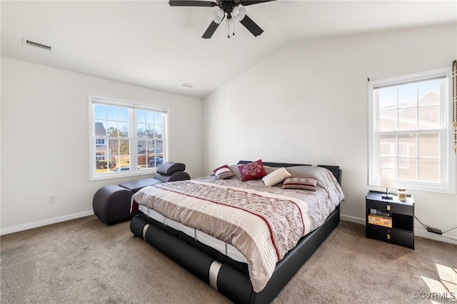 carpeted bedroom with vaulted ceiling, a ceiling fan, visible vents, and baseboards