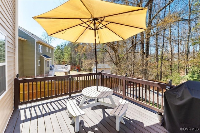 wooden deck featuring a grill