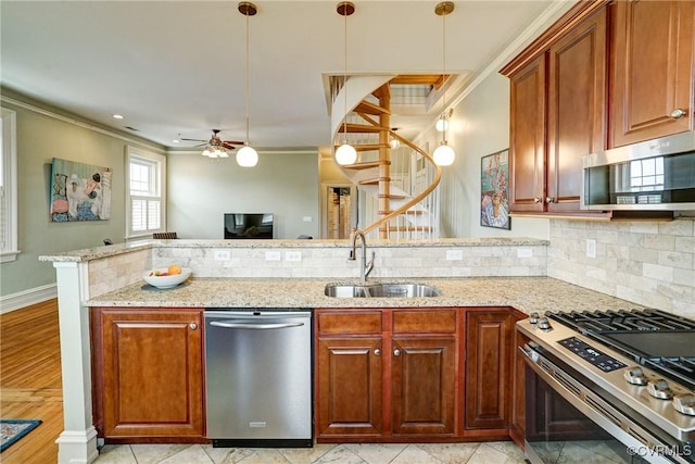 kitchen with stainless steel appliances, a sink, decorative backsplash, a ceiling fan, and crown molding