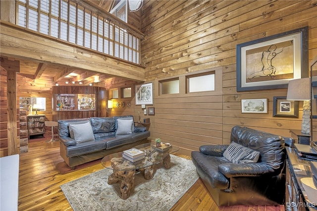 2793 Huguenot Springs Rd, Powhatan, VA 23113 - living room featuring wood walls, hardwood / wood-style flooring, and a towering ceiling