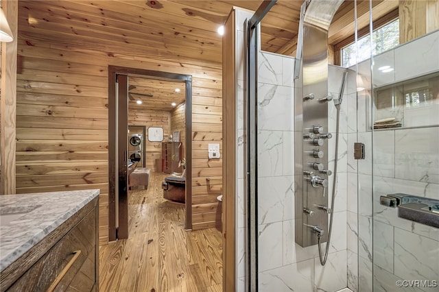 2793 Huguenot Springs Rd, Powhatan, VA 23113 - full bathroom with wood walls, a shower stall, wood finished floors, and vanity