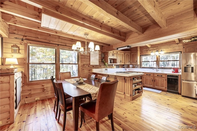 2793 Huguenot Springs Rd, Powhatan, VA 23113 - dining space featuring wood walls, a wealth of natural light, light wood finished floors, and a chandelier