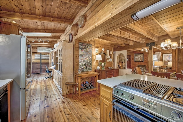 2793 Huguenot Springs Rd, Powhatan, VA 23113 - kitchen featuring appliances with stainless steel finishes, beam ceiling, a chandelier, light wood-style flooring, and wood ceiling
