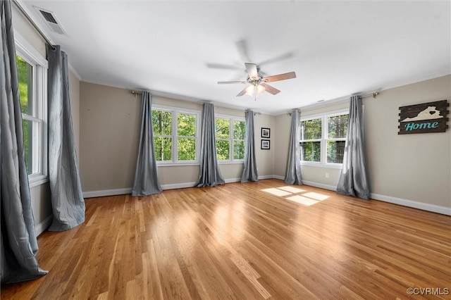 unfurnished room featuring baseboards, a ceiling fan, light wood-style flooring, and visible vents