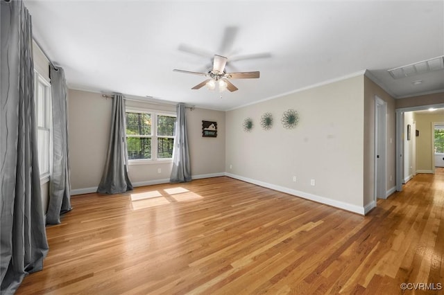 empty room with ceiling fan, visible vents, a healthy amount of sunlight, and light wood-type flooring