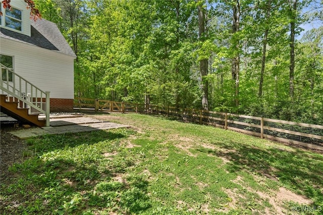 view of yard featuring stairway and a fenced backyard