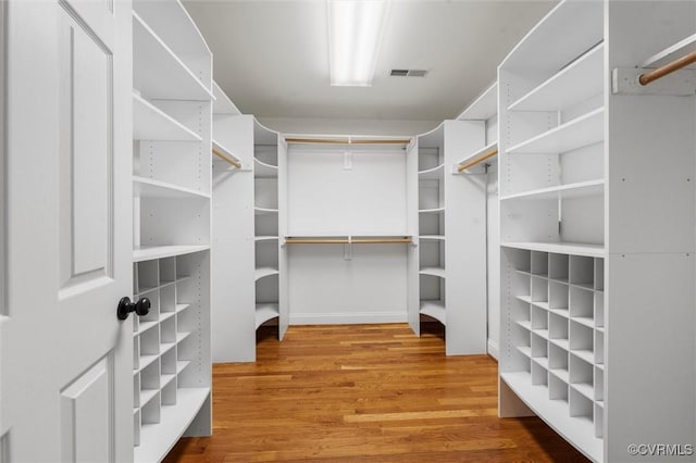 spacious closet with visible vents and wood finished floors